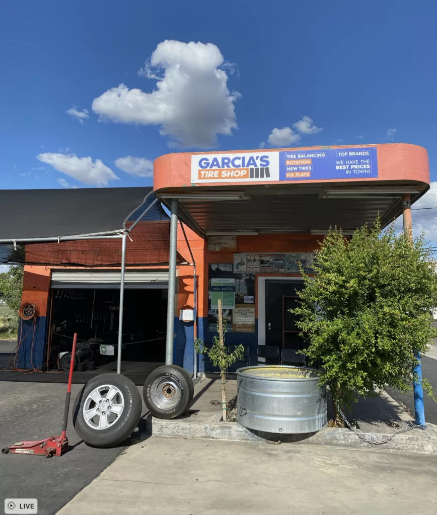 Photo of Garcia’s Tire Shop storefront with the branded service sign installed above the entrance.